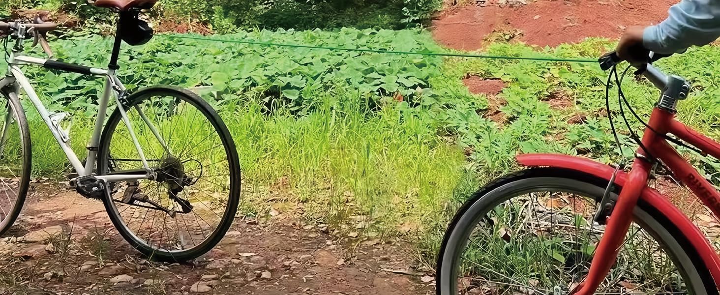 Red bicycle photographed outdoors against lush green vegetation background.