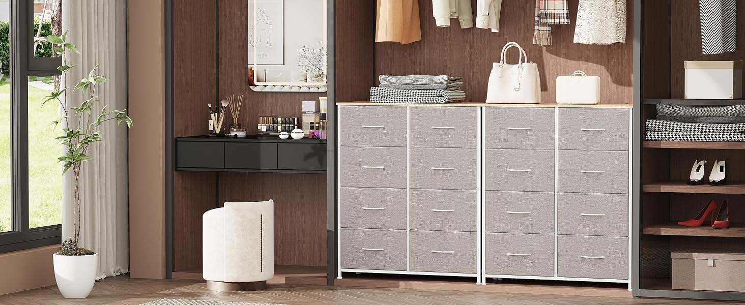 pour chambre à coucher comprenant trois unités à tiroirs en tissu blanc avec plusieurs tiroirs, placées contre un mur en bois foncé. Un petit coin vasque est visible sur la gauche.