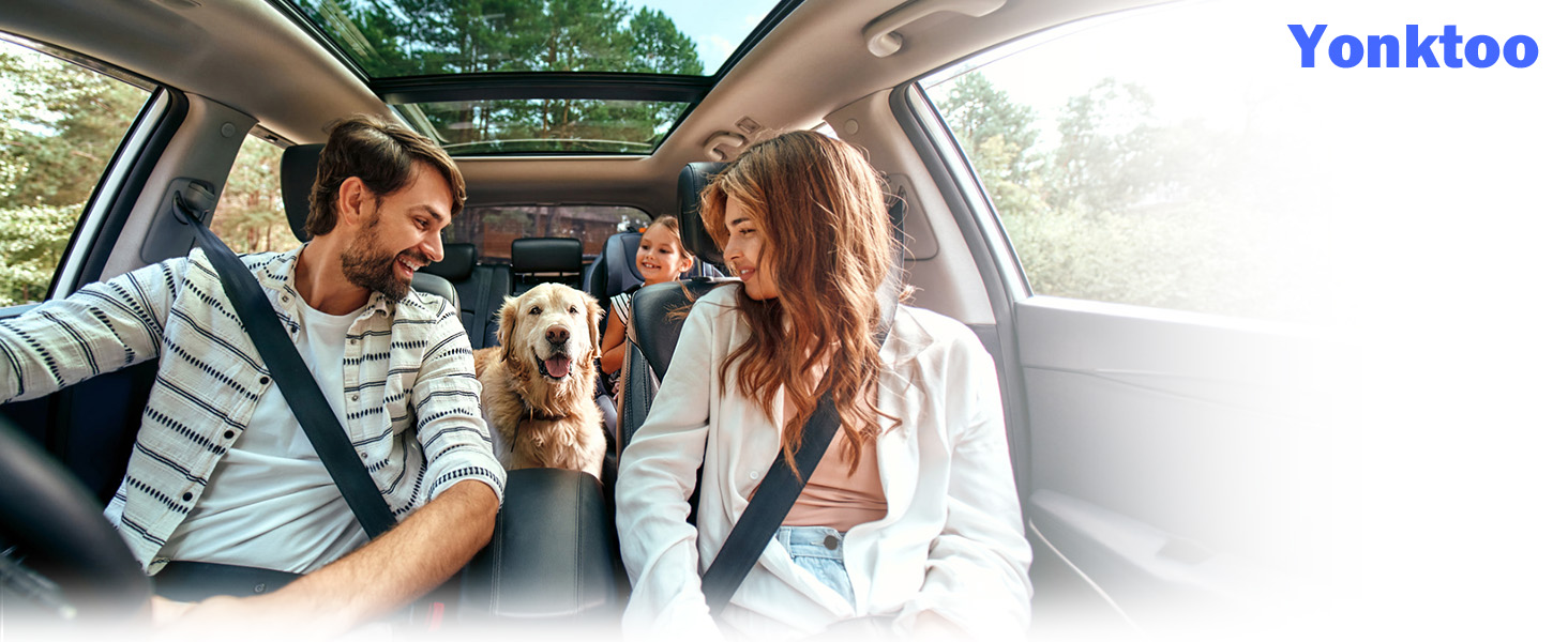 a family with their dog in the back seat of a car.