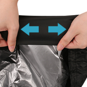 Close-up of hands stretching black fabric with arrows indicating elasticity. Silver material visible underneath.