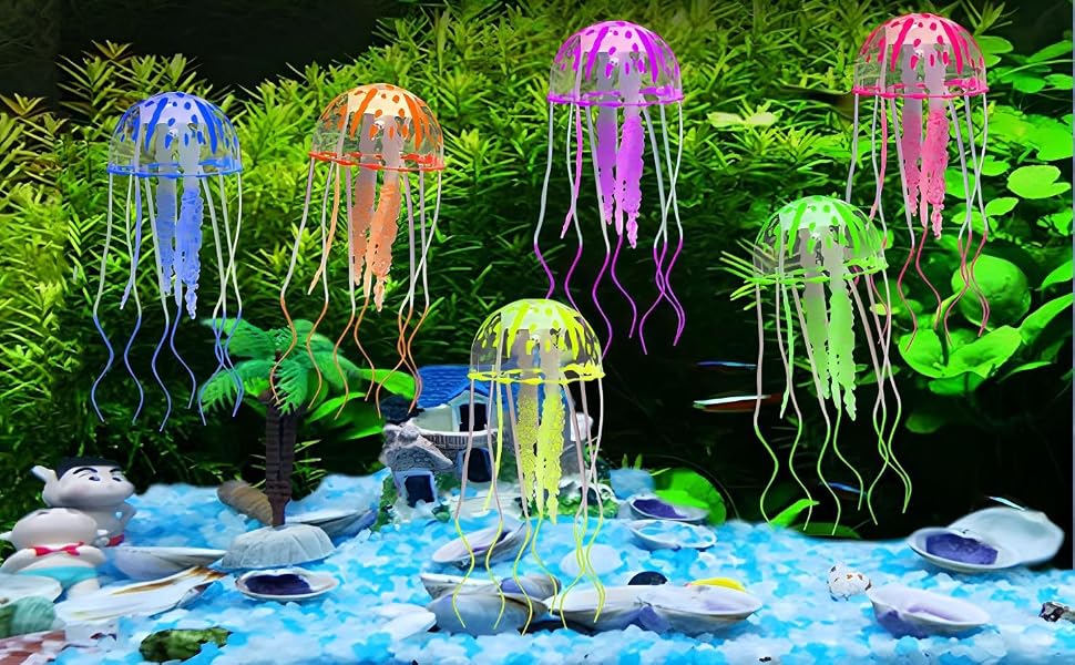 Decorative aquarium jellyfish ornaments in multiple translucent colors glowing with LED lights, floating above blue illuminated base with rocks.
