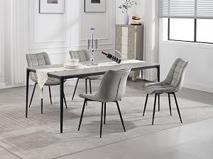 Modern dining set featuring a rectangular table with light-colored top and black metal legs, accompanied by four gray upholstered chairs in a minimalist white room.