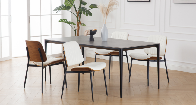 Moderne Essgruppe mit rechteckigem dunklem Tisch und vier Stühlen. Die Stühle verfügen über weiße Sitze, braune Rückenlehnen und schwarze Metallrahmen. Der Tisch hat schlanke schwarze Beine.