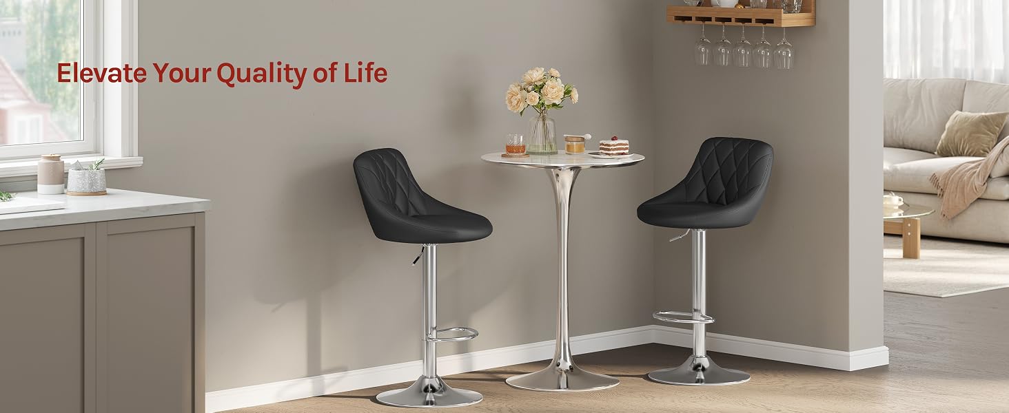 Text reads 'Elevate Your Quality of Life'. Modern room interior with two black bar stools at counter with gold accents and decor.