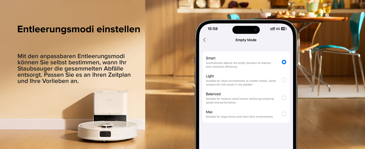 Weißer runder Roboterstaubsauger auf Hartholzboden neben dem Smartphone mit Anzeige des Reinigungsplans. Essbereich mit Stühlen im Hintergrund sichtbar