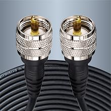 Two silver coaxial cable connectors with gold-plated center pins, attached to a black cable. The connectors feature a knurled grip pattern for easy handling.