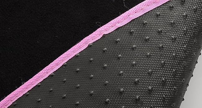 Close-up of fabric with black and gray sections, pink trim, and a perforated pattern on the gray area.