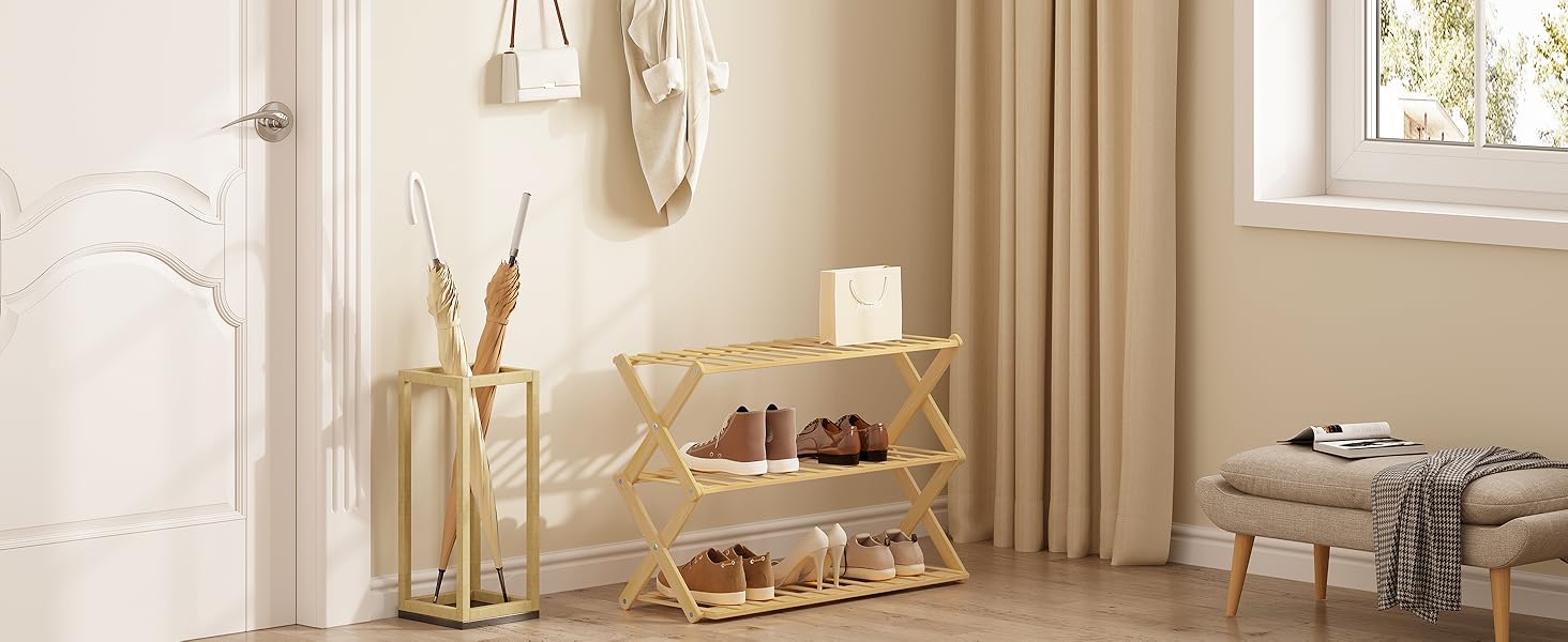 Beige room interior with white three-tier shoe rack, umbrella stand, and small stool. Natural light from window illuminates the space.