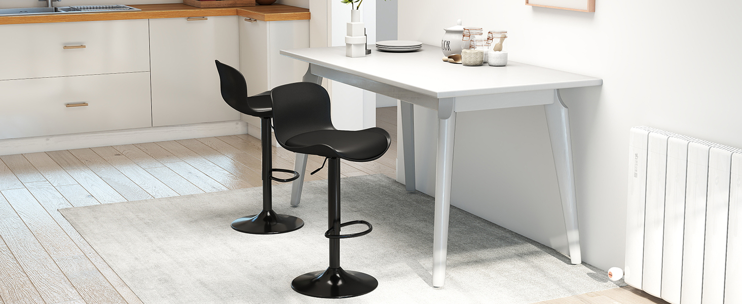 Modern interior design scene with white walls, showing black pedestal bar stools and minimal furniture against bright natural lighting.