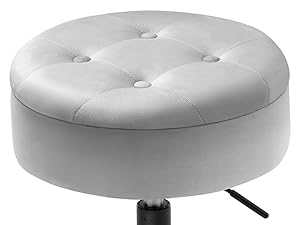 Round white tufted ottoman or stool with a cushioned top. Features button detailing and an adjustable height mechanism visible at the base.