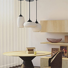a table with a round table with a round top and a round table with a wooden table with a white lamp shade.