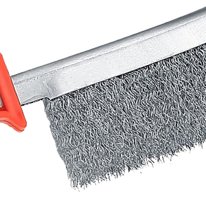 Industrial wire brush with dense metal bristles attached to a red handle, shown in close-up against white background.