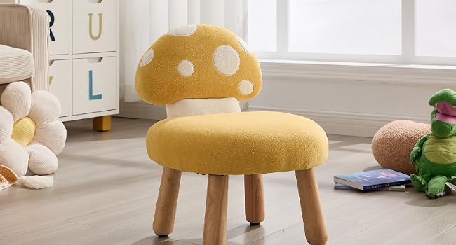 Yellow mushroom-shaped children's stool or chair with white polka dots. Features short wooden legs and a rounded seat design resembling a toadstool or mushroom cap.
