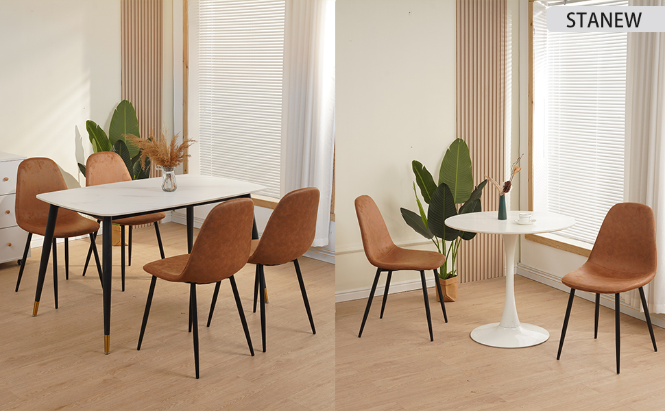 Sala da pranzo moderna con tavolo rotondo bianco, sedie imbottite marroni e grandi finestre con persiane. Le piante in vaso aggiungono verde allo spazio minimalista