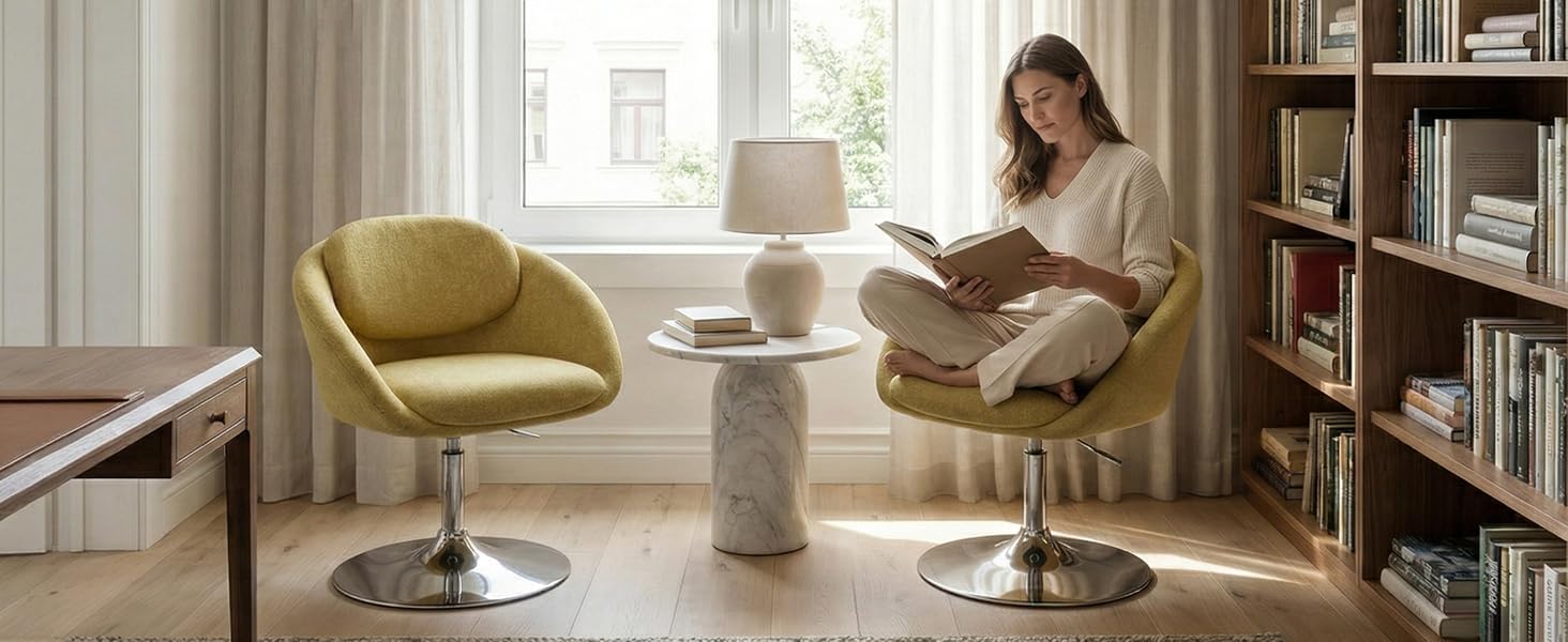 Interior room scene with woman sitting in chartreuse modern armchair near round side table. Bookshelves visible in background. Apalus branded product context showing room setting/installation environment.