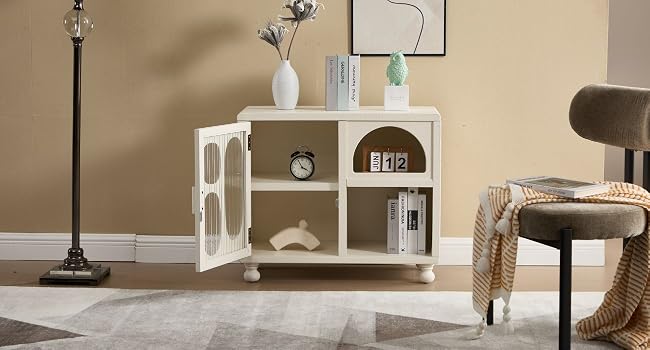 Modern home interior featuring white modular shelving unit against beige wall, with table lamp and decorative items displayed.