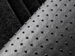 a close up of a metal stair with black and white pattern.