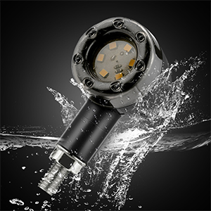 Waterproof electronic device with circular LED face and black cylindrical body, shown with water splashing around it.