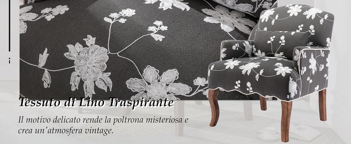 con rivestimento a motivo floreale con fiori bianchi su sfondo scuro. Gambe in legno a vista. Vista parziale della sedia nell'immagine in scala di grigi