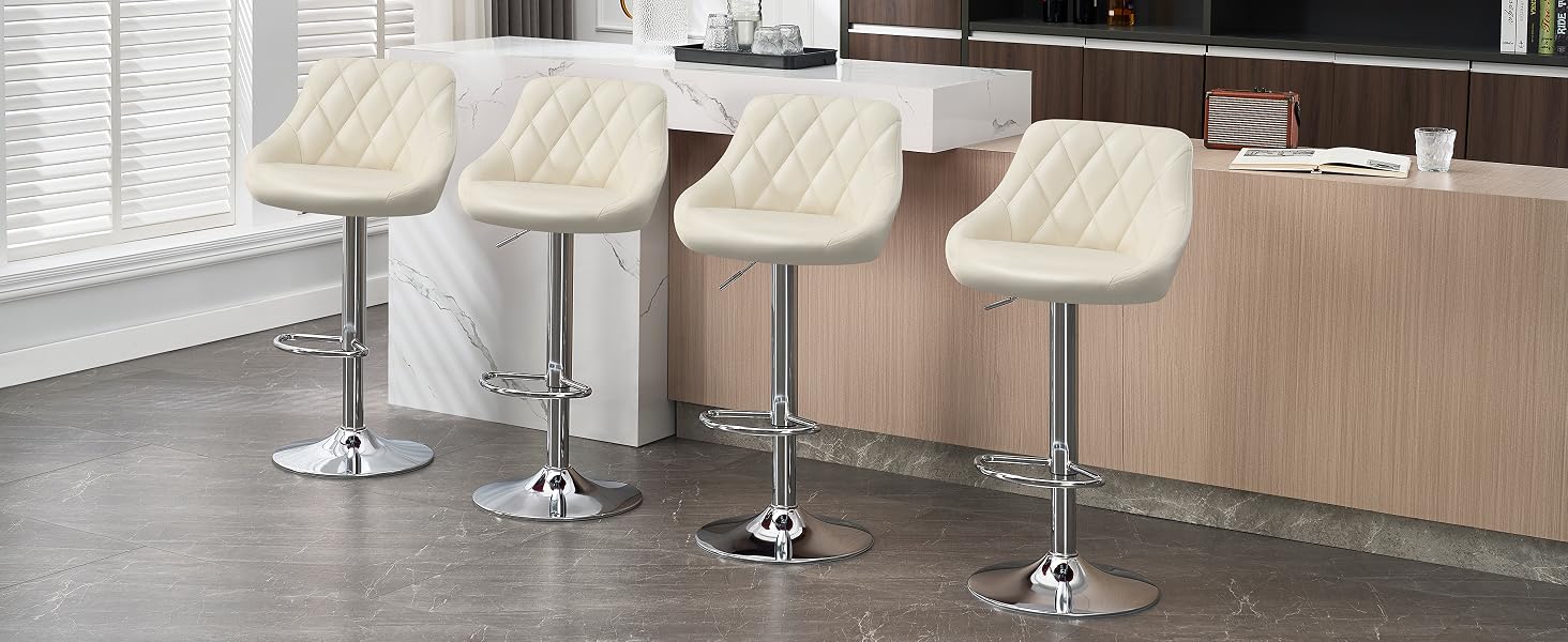 Four cream-colored quilted bar stools with adjustable height and chrome bases, arranged in a row along a kitchen counter or bar.