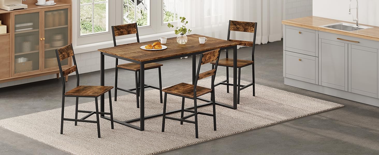 Rustic dining set with rectangular wood-top table and four matching chairs. Black metal frames contrast with warm wood tones. Set on patterned area rug in kitchen setting.