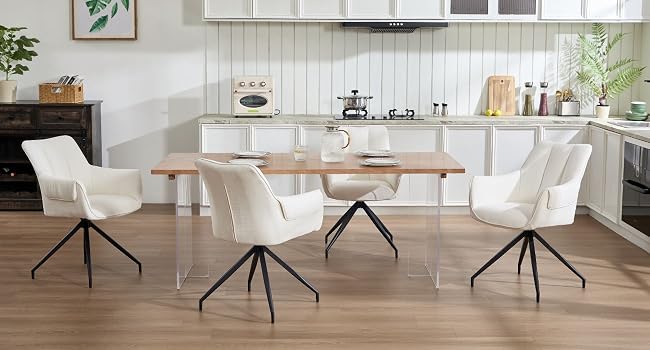 Comedor moderno con sillas tapizadas en blanco con patas de metal negro alrededor de una mesa de madera, colocadas contra paredes con paneles blancos y pisos de madera.