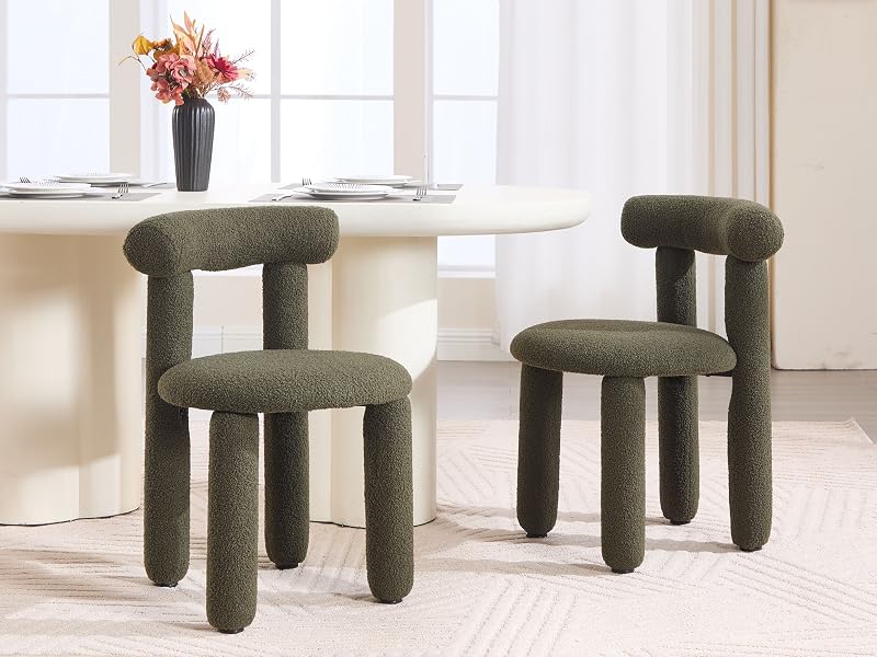 Set aus grauen gepolsterten Hockern oder Stühlen mit dicken, zylindrischen Beinen, angeordnet in einer hellen Inneneinrichtung mit Blumenarrangement.