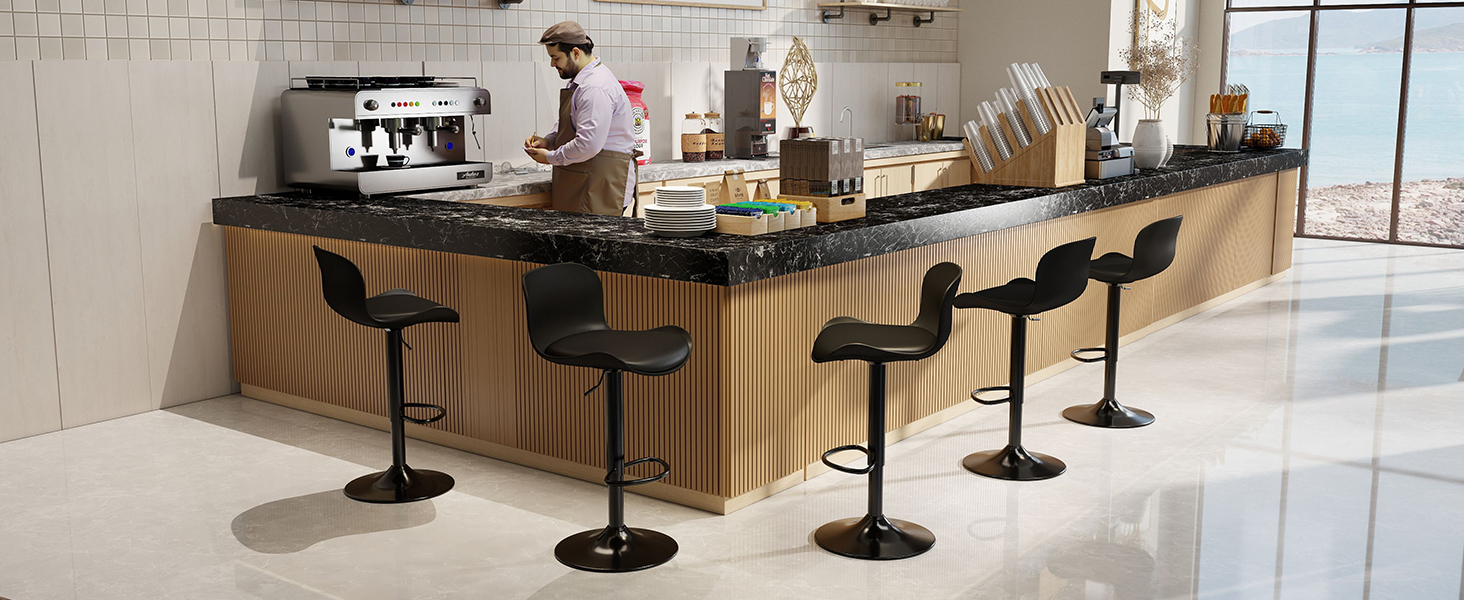 Modern restaurant or cafe interior with multiple black bar stools and wooden counter seating arranged in a row along windows.
