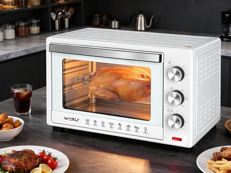 Forno a convezione da banco in cucina con prodotti alimentari esposti, tra cui patatine fritte e piatti da forno.
[SENTENCE 15] Design in acciaio inossidabile con manopole di controllo.