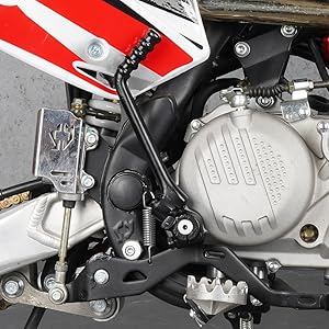Close-up detail of a motorcycle engine component showing mechanical parts, mounting brackets, and metal housing in black and silver finish.