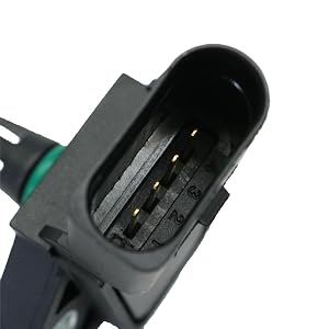 Close-up of a black electrical connector with multiple metal pins visible inside the oval-shaped opening.