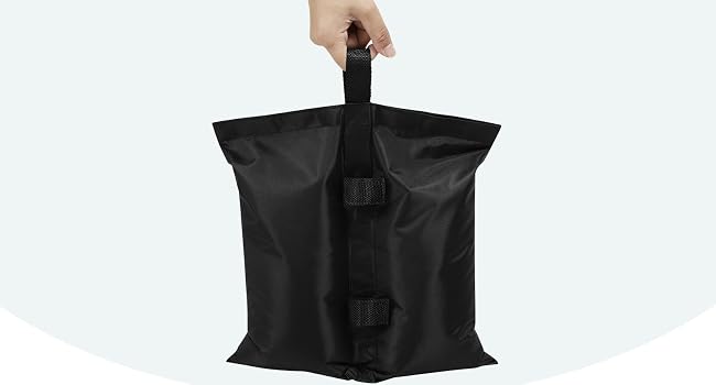 Black reusable sand-filled bag with handle. Three-panel illustration shows usage: sand pouring in, bag filled, and bag closed.
