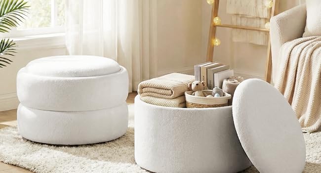 White cylindrical ceramic containers and decorative vessel arranged on beige carpet. Minimalist home decor setup with neutral tones and simple geometric forms.
