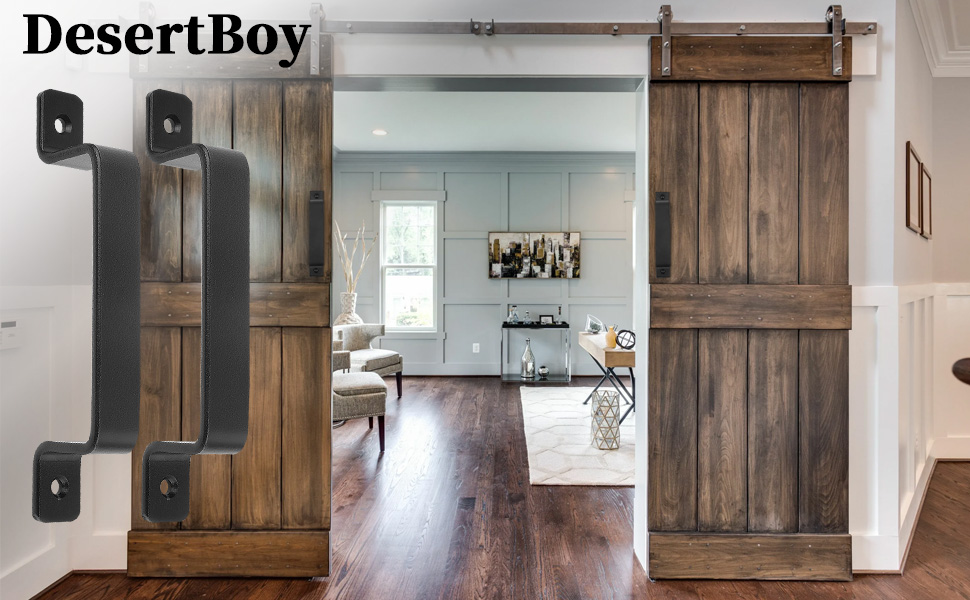 Rustic sliding barn doors with dark metal handles, revealing a modern interior room. Wood flooring visible through the doorway. DesertBoy brand text visible.