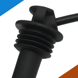 Close-up of black rubber or plastic stopper with ribbed design, shown against white background.