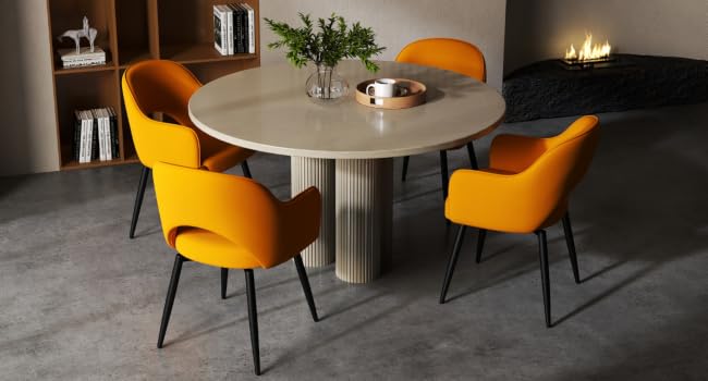 Modern dining set with round stone-top table and four vibrant yellow upholstered chairs. Table features a fluted pedestal base. Wooden bookshelf and fireplace visible in background.