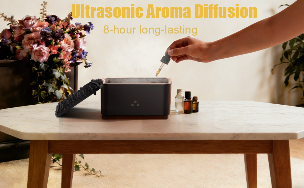 Text reads: 'Ultrasonic Aroma Diffusion', '8-hour long-lasting'. Shows black device on wooden table with essential oil bottles and flowers nearby.