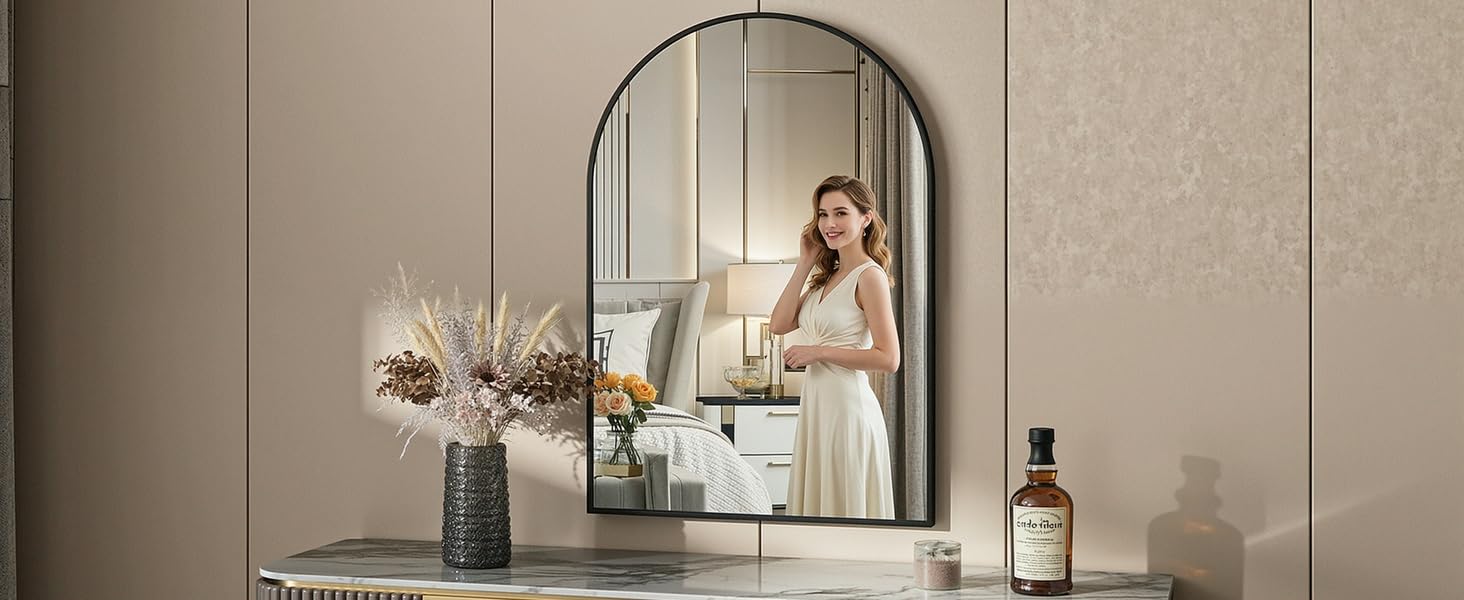 Interior scene showing beige wall panels with decorative mirror, vase with flowers, and elegant room styling.