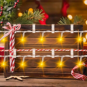 a wooden box with lights and candy canes