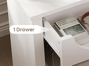 Le texte indique 'Tiroir spacieux et station de charge'. Table de chevet blanche avec tiroir montrant la fonction de charge du téléphone et l'espace de rangement.