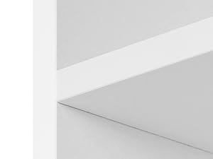 Minimalist architectural interior showing white walls meeting at clean angles, creating geometric shapes with subtle shadows.