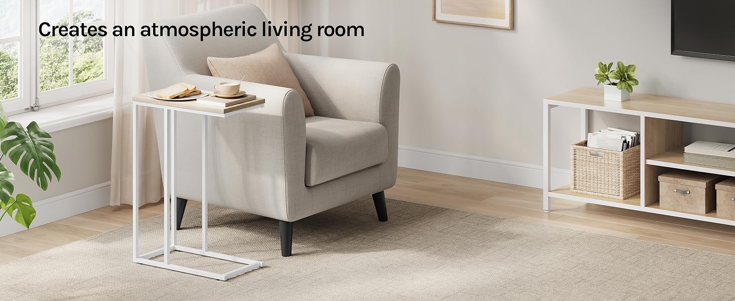 Living room setup with beige armchair, white side table, area rug, and storage unit. Window and TV visible. Text overlay reads 'Creates an atmospheric living room'.