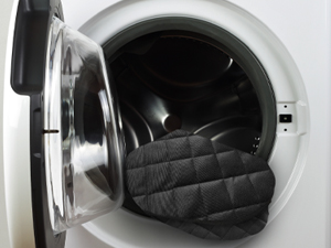 a washing machine with a glove inside of it.