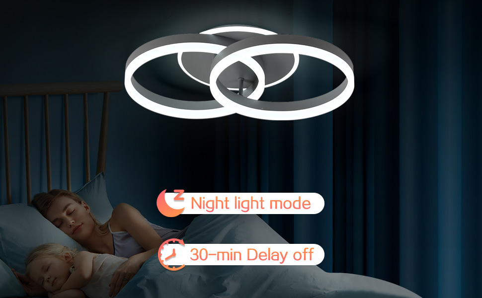 Runde LED-Deckenleuchte mit ineinandergreifenden Ringen. Verfügt über einen Nachtlichtmodus und eine 30-minütige Ausschaltverzögerung. Beleuchtet im dunklen Schlafzimmer mit schlafender Person.