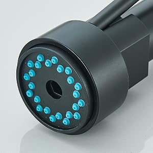 Primer plano de un dispositivo cilíndrico negro con una matriz circular de luces LED azules, posiblemente un componente de cámara o sensor