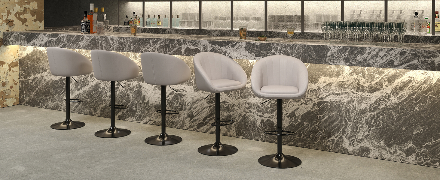 Row of metal stanchions with retractable belts arranged along a stone or concrete wall outdoors.