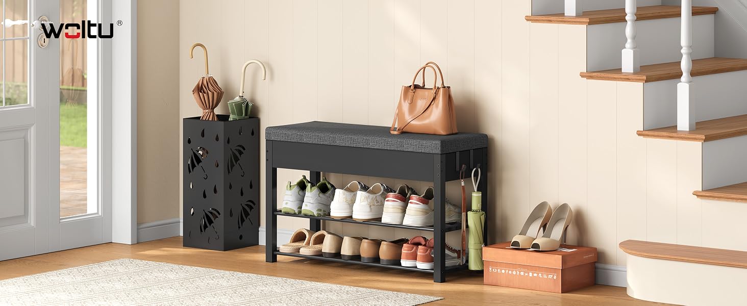 Text reads "waldi" in top left. Entryway storage setup with dark patterned storage bench, shoe rack with multiple pairs of shoes, hanging coats, woven baskets, and wooden floor in bright room with shelving.