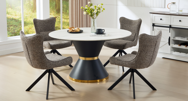 Modern dining set featuring round white table with black and gold pedestal base, surrounded by four gray upholstered swivel chairs in bright room setting.