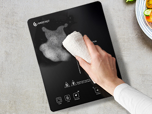Essuyer à la main une élégante balance de cuisine numérique noire avec un chiffon. La balance affiche des icônes lumineuses pour différentes fonctions sur sa surface.