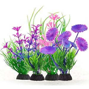 Artificial aquarium plants with vibrant purple and pink flowers attached to black bases, featuring green plastic stems and leaves arranged in increasing quantities.